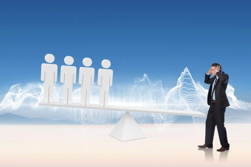 stressed-businessman-with-hands-head-against-white-human-resource-scales-desert-min stressed-businessman-with-hands-head-against-white-human-resource-scales-desert-min
